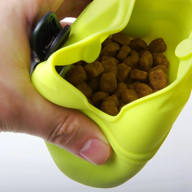 Close-up view of treats inside a yellow dog treat pouch with an easy-access magnetic opening.