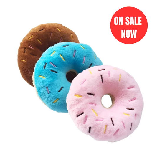 Donut-shaped squeaky dog toys in pink, blue, and brown with soft plush design - On Sale Now