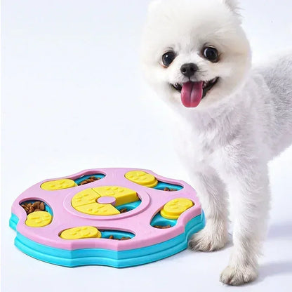 White dog with a pink and blue puzzle toy filled with treats on a white background