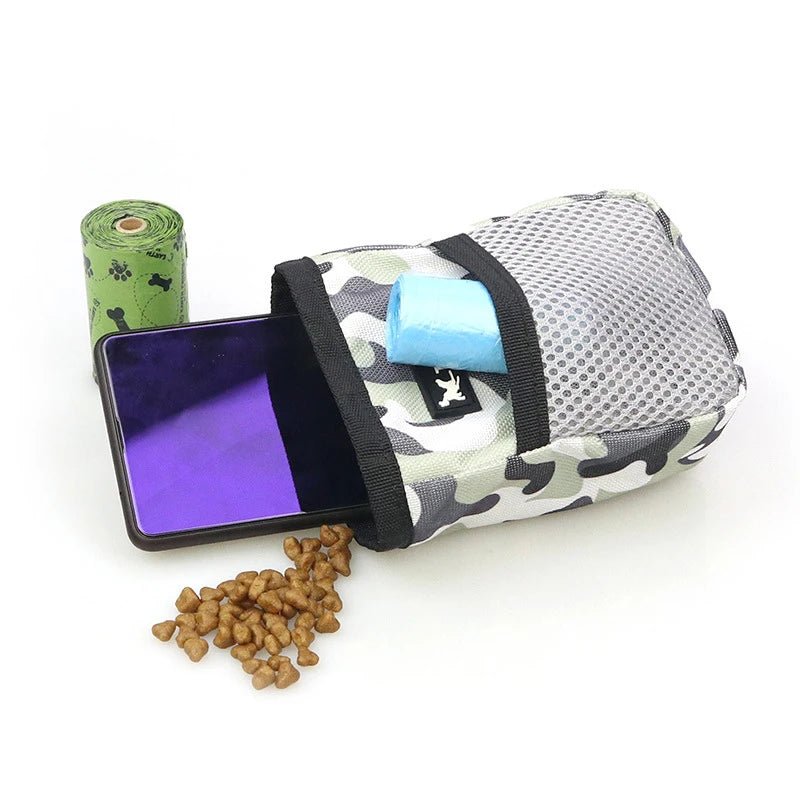 Camouflage dog treat pouch open on a table showing storage for treats and a smartphone