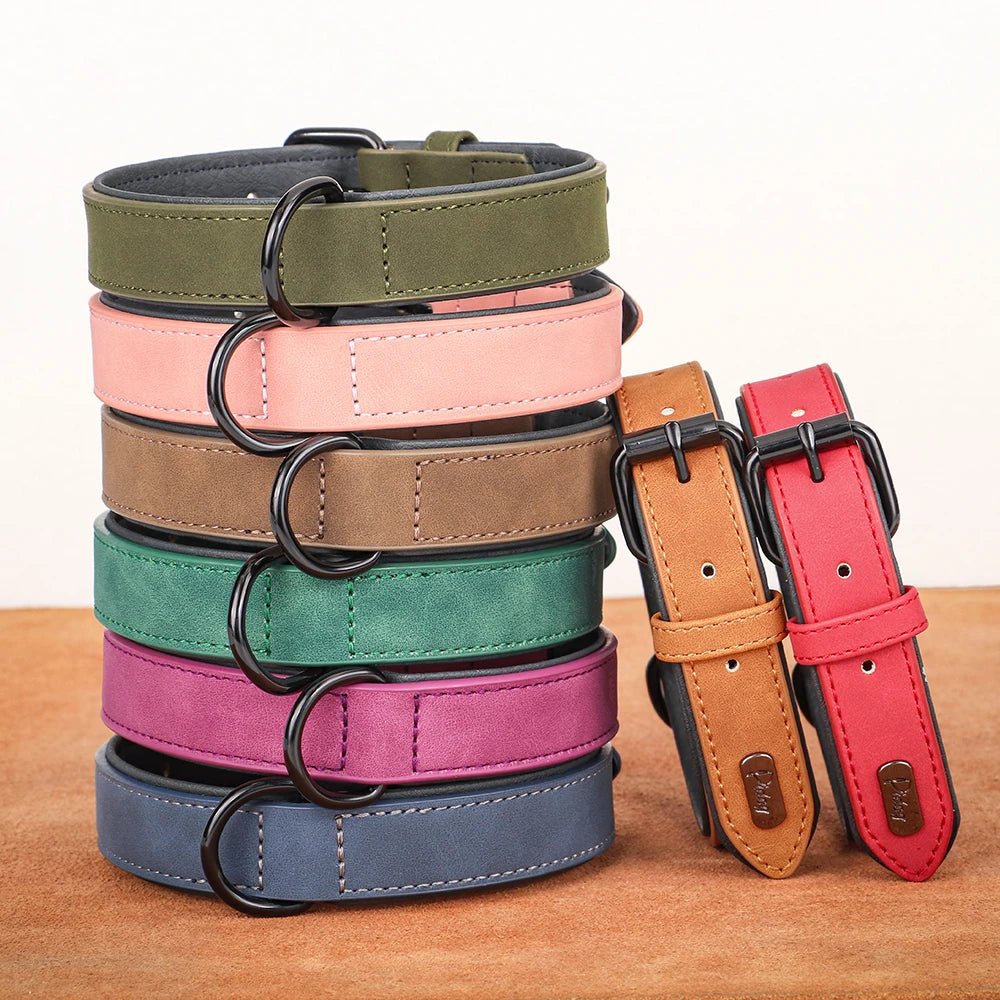 A rolled bundle showing a collection of leather dog collars in green pink purple teal orange and brown colors