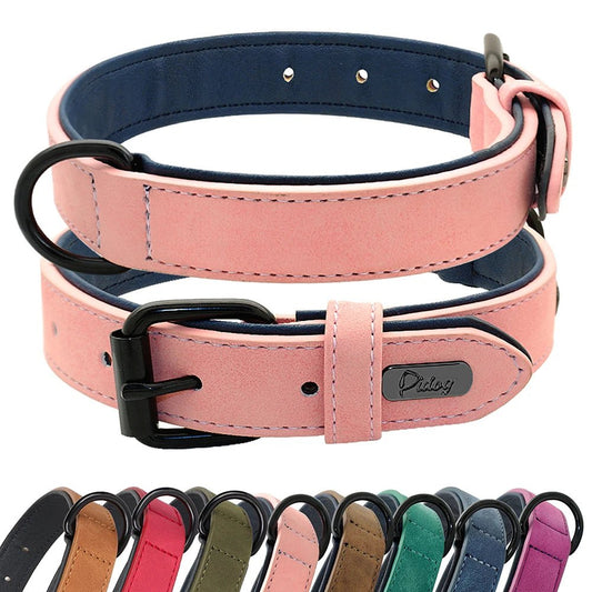 Two pink soft padded PU leather dog collars with black metal adjustable belt buckles stacked on a clean white background
