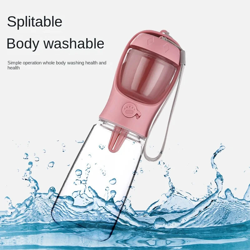 Pastel pink splitable body-washable dog travel water bottle angled amidst refreshing water splashes