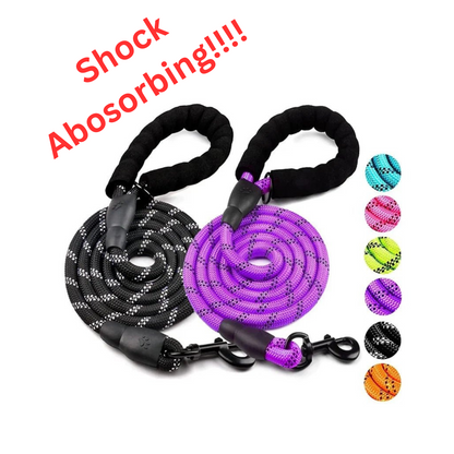 A black and a purple shock absorbing reflective dog leash with padded foam handles displayed against a white background